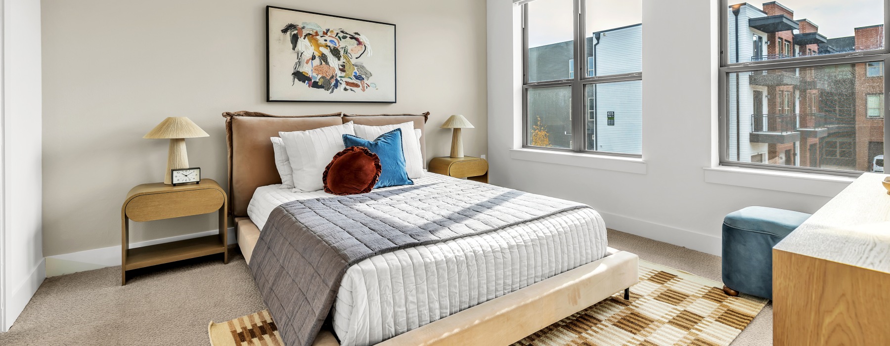 Carpeting and large windows inside apartment bedrooms at The Grove at La Frontera